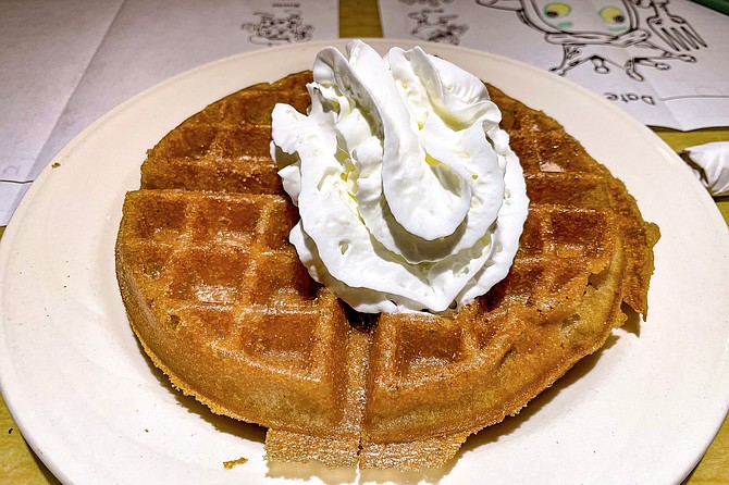 A churro waffle, coated in sugar and cinnamon