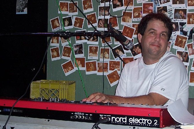 Chuck Charles likes to keep one hand free for his beer while he’s tickling the ivories.