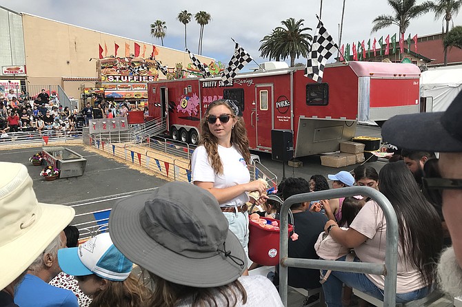 Zach’s family member selling pig noses for enthusiasts, while awaiting actual pig races.