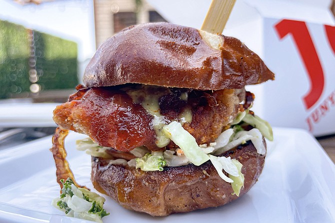 A karaage chicken slider with sesame slaw and spicy red sauce