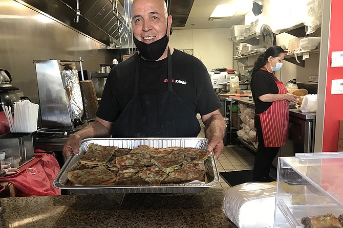 Owner Rohullah Attaire with tray of Bolani.