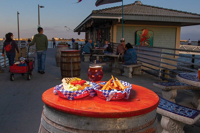 Dennis Borlek was five years old when his father taught him how to fish on the Shelter Island Pier. That charming bit of history may help explain why diners will find burgers and sausages at the pier’s bait shop today.