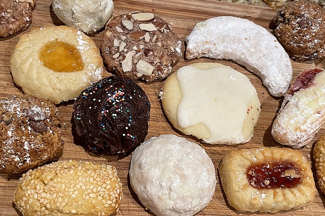 Italian cookies, including lemon and chocolate ricotta cookies (center), sugar dusted snowballs with nuts, Sicilian chocolate chip (top right and bottom left), and more