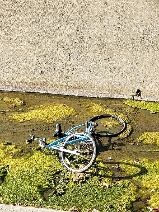 Bike in stormwater canal along Escondido's Creek Trail.