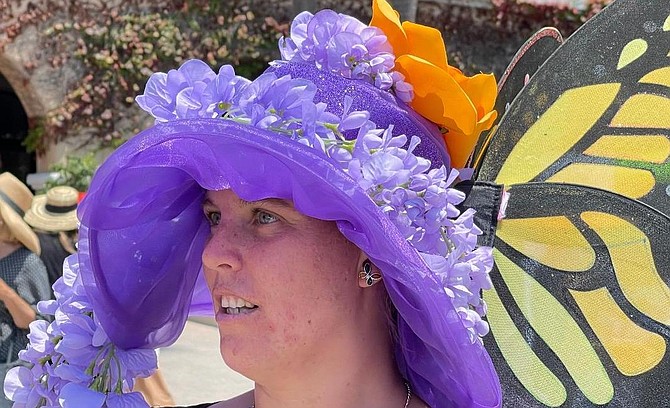 Amber from Escondido wearing butterfly wisteria hat. She's entered opening day hat contest for 10 years.