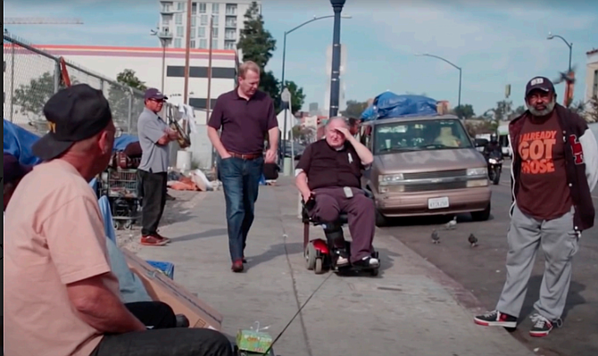 A montage featured the future mayor walking East Village streets with the priest.