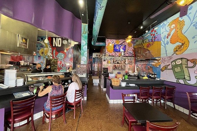 Colorful walls inside a small sushi bar