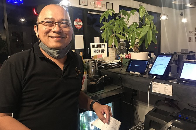 Manager Win, sweetens dishes for local tastes.
