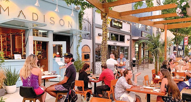 The Madison on Park parklet occupies a half block of what used to be parking spaces along Park Boulevard.