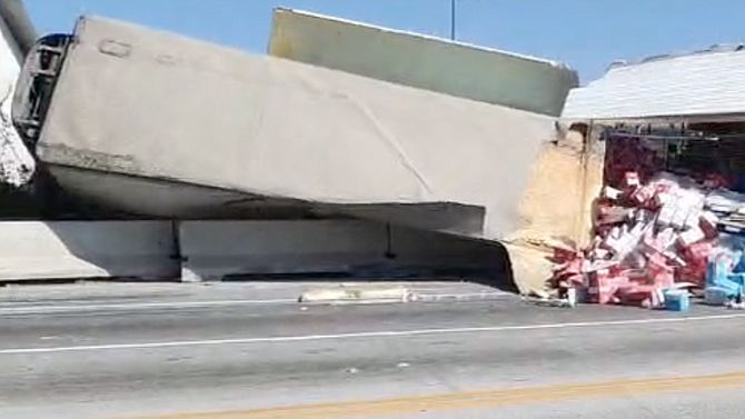 A truck and trailer filled with LALA milk products toppled over in Rosarito.
