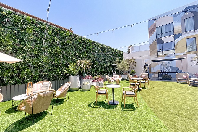 The verdant, Westerly dining courtyard, built within Shelter Island's new Monsaraz hotel