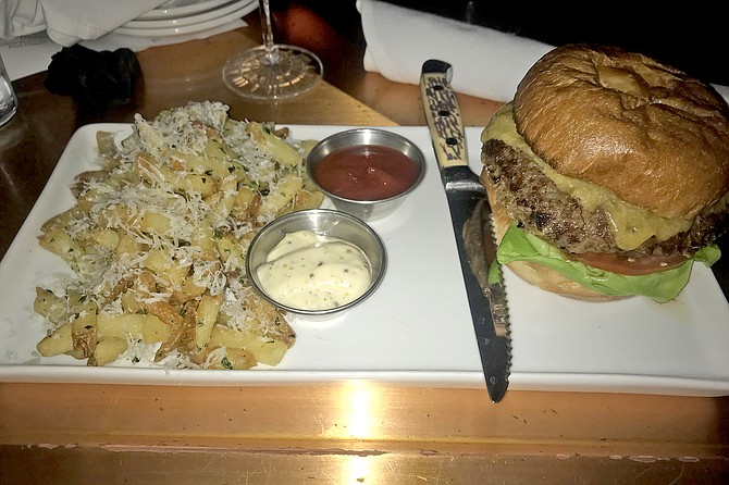 Neighbor’s burger ($19, with truffle fries, but Happy Hour price is $12, including beer).