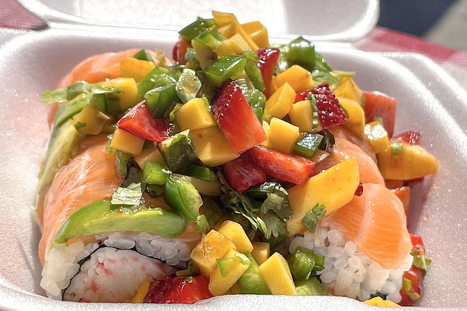 The Lovers Roll: salmon, krab, and avocado, topped with a pile of diced mangos, strawberries, jalapeños, and cilantro