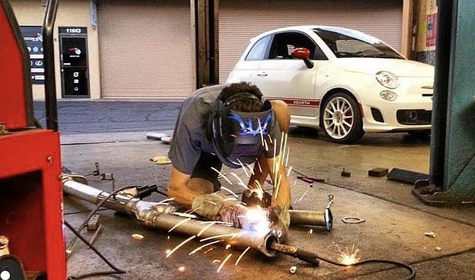 Justin Goen in Escondido welding a catalytic-converter pipe