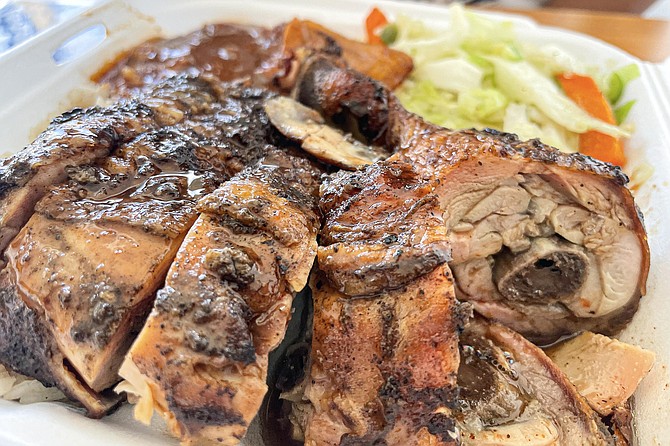 A chopped up order of a nicely charred jerk chicken