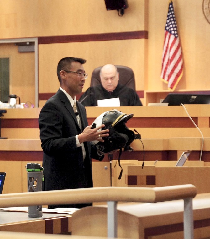 Prosecutor Keith Watanabe showed the damaged cop helmet to the jury. Photo by Eva Knott.