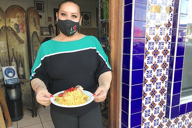 Toñico’s widow, Yolanda, holds my half serving of their famous paella.