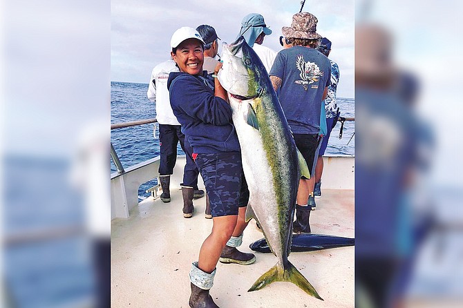 Angler Sophia Huynh with her personal best 67.8-pound yellowtail caught aboard the Shogun while fishing at Guadalupe Island.