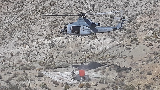 Helicopter dumping bucket into guzzler