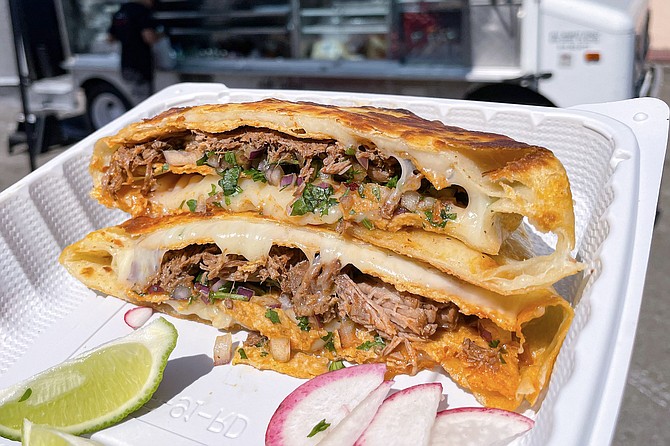 The Crunchstack: beef birria, onions, and cilantro, sandwiched in crispy corn tortillas, wrapped in grilled flour tortilla and melted cheese