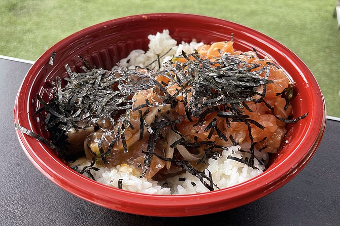 A medium (two scoop) poke bowl featuring garlic salmon poke and ahi poke with oyster sauce