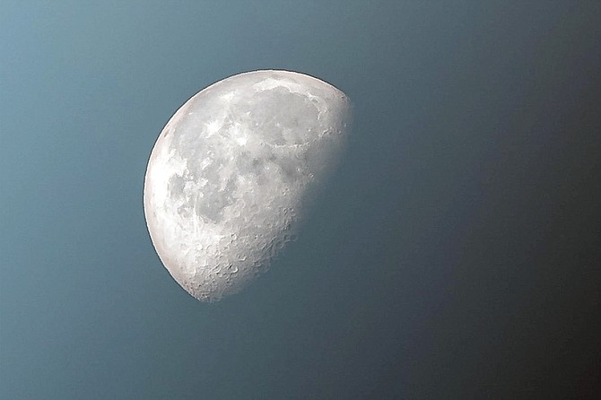 Decreased albedo due to cloudiness leads to a slight dimming of the moon.