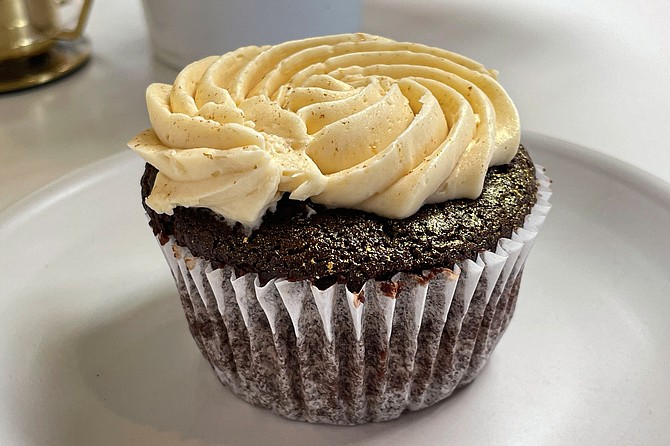 A gluten-free cupcake with chocolate chips and caramelized honey, Italian buttercream