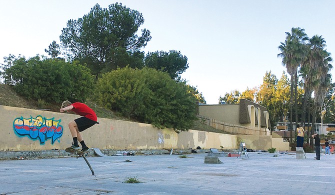 A homemade skate park of surprising quality — someone mortared cinder blocks, built forms, mixed and poured concrete, smoothed curves, and embedded metal trim to make the potential of the extant slab into the actuality of something cool.
