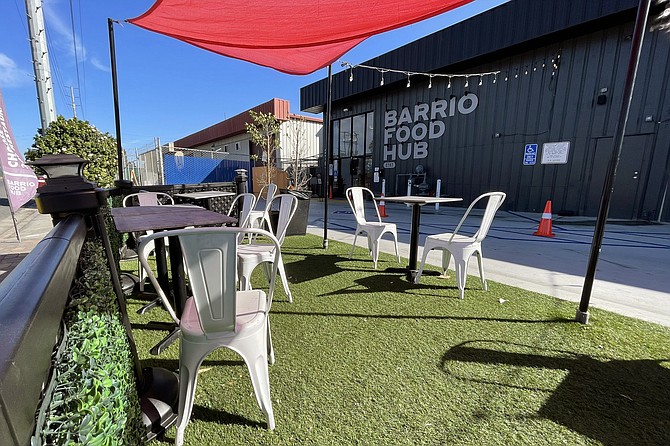 You can watch delivery drivers come and go while eating at the parklet outside this commercial kitchen complex.