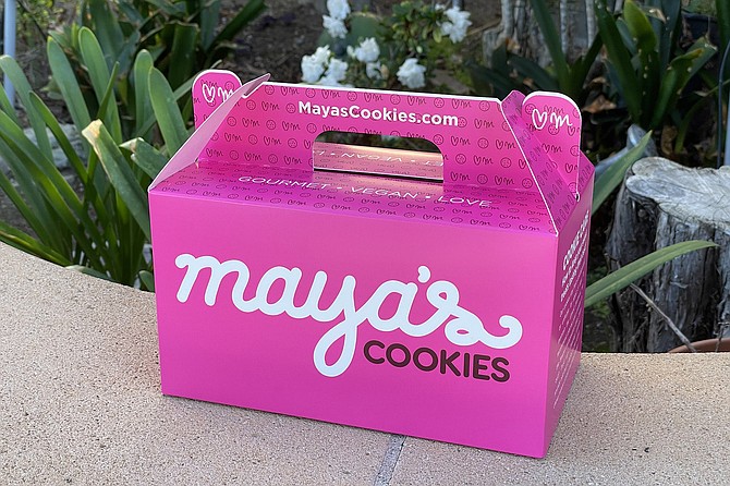 A pink box of vegan cookies for the family