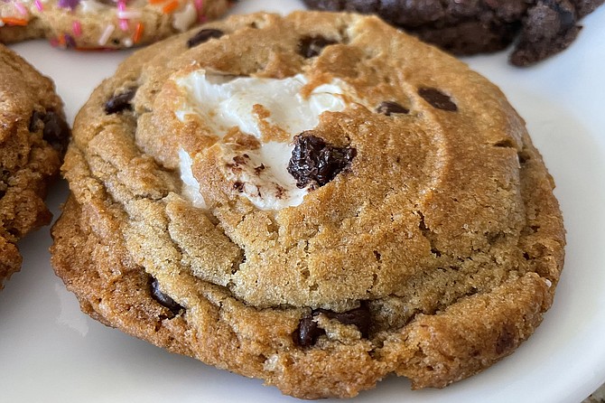 A s'more chocolate chip cookie, with a puddle of marshmallow at its center