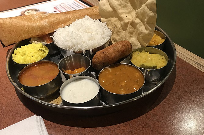 What $14.99 buys. Two curries, lemon rice, fried lentils, dal fry, sambar lentil soup, lentil donut, chana masala garbanzo, beetroot poriyal, dosa, papadam, three chutneys.