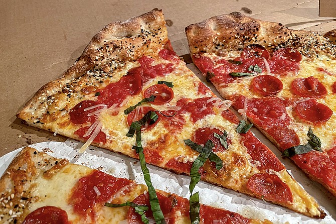 A flavorful take on New York style pizza. with everything bagel toppings added to the crust