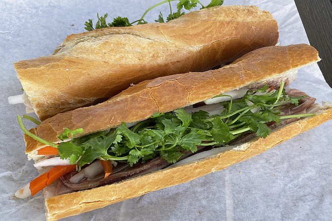 A pair of traditional, pork-based bánh mì, featuring the likes of pork belly, pork loaf, ham, and pâté