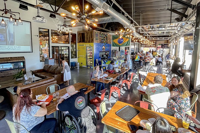A Saturday crowd fills tables within the market.