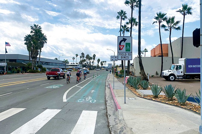 Bicyclists riding outside the bike lane, in the sharrows, on Coast Highway, Encinitas