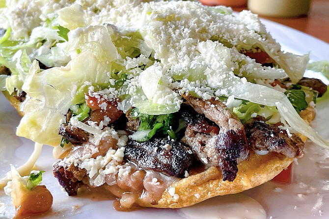 A huarache: made like a tostada, with a large piece of masa shaped like a sandal