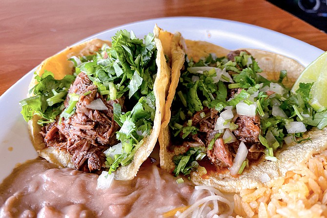 Goat birria tacos, served on freshly-made corn tortillas