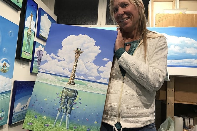 Elisabeth Sullivan with a copy of her famous “giraffe” painting.