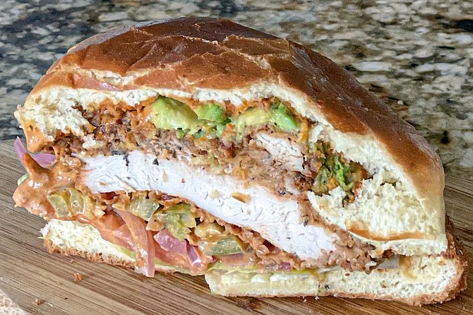 A cross section of the Cali Chick,the rare fried chicken sandwich that is topped with avocado