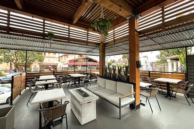 Shared patio seating for a birria counter, mariscos counter, and soon-to-be donuts and coffee