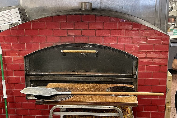 A red pizza oven turns out manoushe in the Sahara kitchen.