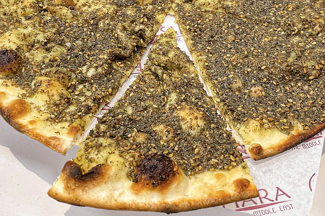 Straight out of the pizza oven, but there's no tomato sauce on the za'atar flatbread served by Sahara, and cheese is optional.
