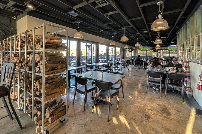 A spacious patio and dining room, with mounted televisions keeping it casual