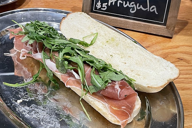 A five dollar grab-and-go sandwich of prosciutto and arugula