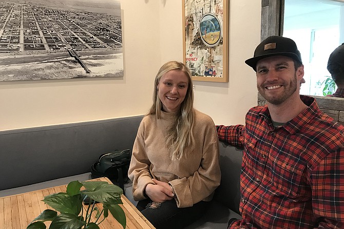 Regular customer Katelyn with owner Mike. Historic PB on wall behind.