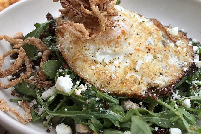 My Superfreak Bowl breakfast: arugula and lots of quinoa. Goat cheese adds kick