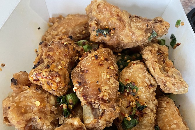 Salt and pepper wings with red chili flakes, green onions, and a "secret" seasoning