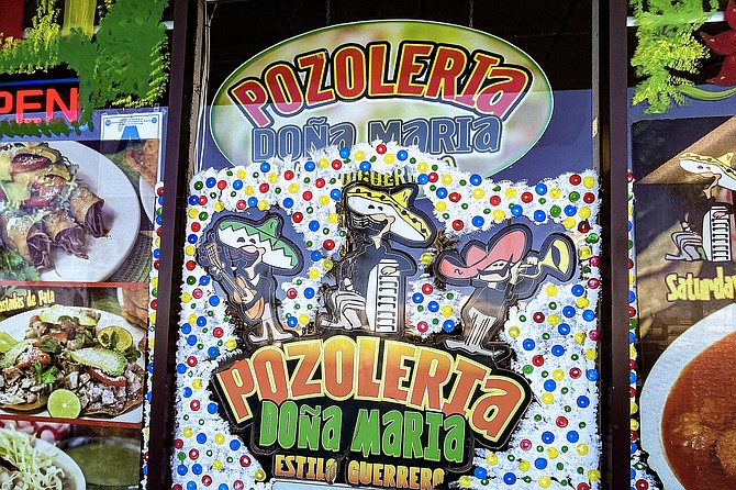 Mustachioed mariachi players decorate the entrance of Pozoleria Doña Maria, a restaurant operating on both sides of the border.