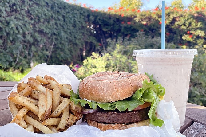 Vegan food doesn't have to equal health food: burger, fries, and a non-dairy milkshake.